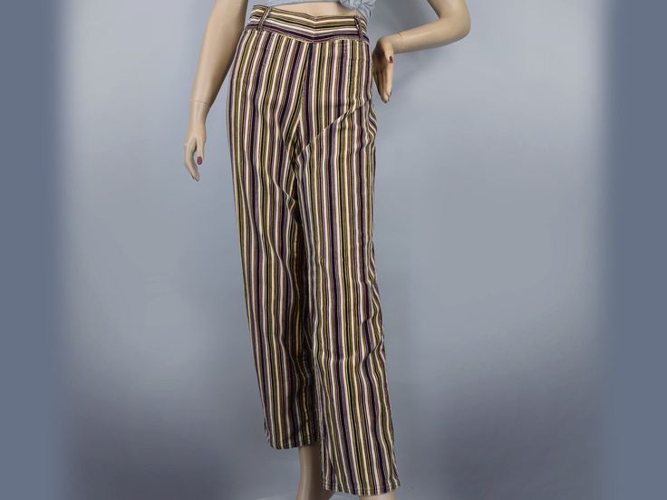 This fun pair of vintage 60s pants are a bold statement piece! The coloring is reminiscent of Neapolitan ice cream, with chocolate brown, strawberry pink, and vanilla cream...with a bit of lemon yellow for good measure. The stripes are not only fun colors, they are lines of corduroy fabric, so they have a fun ridged texture, as well as a soft fuzzy feel.   The wide waistband has a slight V-dip at the front and back, plus loops for a belt, if you choose to add one. It closes at the side with snaps and a zipper. The legs are a fairly straight cut from hip to hem. Shallow scoop pockets set at the front hip on each side.   These are nicely made, judging from a sewing standpoint, with care taken to match the lines as they meet at the center seams, along the leg, and along the inseam. It's not s Retro Brown Pants For Spring, Retro Brown Bottoms For Spring, Vintage Striped Pants For Spring, Vintage Multicolor Spring Pants, Vintage Multicolor Straight Leg Pants, Multicolor Vintage Straight Leg Pants, Vintage Striped Fitted Pants, Vintage Multicolor Cotton Pants, Vintage Striped Pants For Summer