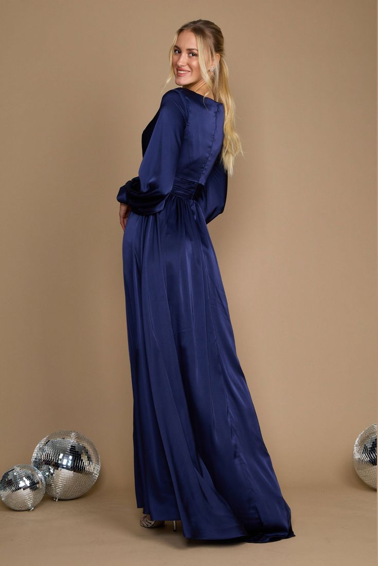 Are you trying to find the ideal long dress that will make you feel both gorgeous and at ease? Check out this gorgeous long-sleeved formal dress! It has a chic split a-line skirt that will accentuate your attractive legs, a trendy and elegant peplum-style bodice, and romantic long sleeves. Elegance, beauty, and comfort are personified in this outfit. Excellent for any special event! Fabric: Satin Length : Full Length Sleeve Style : Long Sleeve Color : Black, Navy Sizes : 8, 10, 12, 14, 16, 18, 2 Floor-length Maxi Dress For Prom Season Date Night, Glamorous Long Sleeve Dress With Side Slits, Glamorous A-line Maxi Dress For Party, Fitted Long Sleeve Floor-length Dress For Night Out, Long Sleeve Cocktail Dresses With Side Slits, Blue Long Sleeve Party Dress For Fall, Blue Long Sleeve Dress For Fall Party, Chic A-line Maxi Dress For Party Season, Chic Maxi Dress With Side Slits For Prom Season