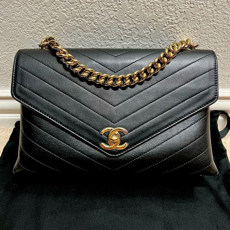 Brand: Chanel Style: Coco Chevron Envelope Flap Color: Black Hardware Color: Gold Leather: Calfskin Size: 11.5"W X 7"H X 3.5"D 4" Handle Drop 21" Strap Drop Condition: Great Condition, Light Scratches On Hardware, Light Scuffs On Exterior Of Bag. Interior Clean, No Stains, Or Smell. Ships With: Dust Bag (Not Original Dust Bag) All Items That I Sell Are 100% Authentic! Vintage Chanel Bag, Chanel Style, Interior Clean, Bag Interior, Chanel Fashion, Black Hardware, Vintage Chanel, Gold Leather, Flap Bag