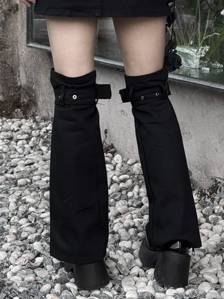 Add a touch of punk flair to your look with these edgy buckle strap leg warmers. The black color and zip closure give them a sleek, modern feel, perfect for adding an alternative edge to any outfit. These leg warmers feature buckle straps for added detail and a secure fit.   Please note that this product includes only one pair of leg warmers. Punk Style Leg Warmers For Cosplay, Black Thigh-high Leg Warmers For Streetwear, Black Thigh High Leg Warmers For Streetwear, Black Cyberpunk Winter Bottoms, Trendy Black Bottoms With Belt, Punk Style Thigh High Leg Warmers For Alternative Fashion, Black Punk Bottoms With Belt, Punk Black Bottoms With Belt, Black Edgy Leg Warmers For Cosplay