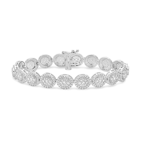 Dare to dazzle in a bold yet timeless style when you wear this round multi-diamond frame line bracelet in white gold. Crafted in cool 10K white gold Round diamond composites sparkle in halo frames of smaller diamonds. Magnificent with 5 cts. t.w. of diamonds. This 7.0-inch bracelet secures with a box clasp. Dazzling Round Diamond Bracelet With Pave Setting, Sterling Silver Bracelet With Pave Diamond Setting, White Pave Setting Tennis Bracelet, White Round Tennis Bracelet With Pave Setting, White Gold Diamond Bracelet With Pave Setting, White Diamond Bracelet With Accents, Formal White Gold Tennis Bracelet With Halo Setting, Formal Diamond Bracelet With Halo Setting, Timeless Diamond Bracelet With Pave Setting