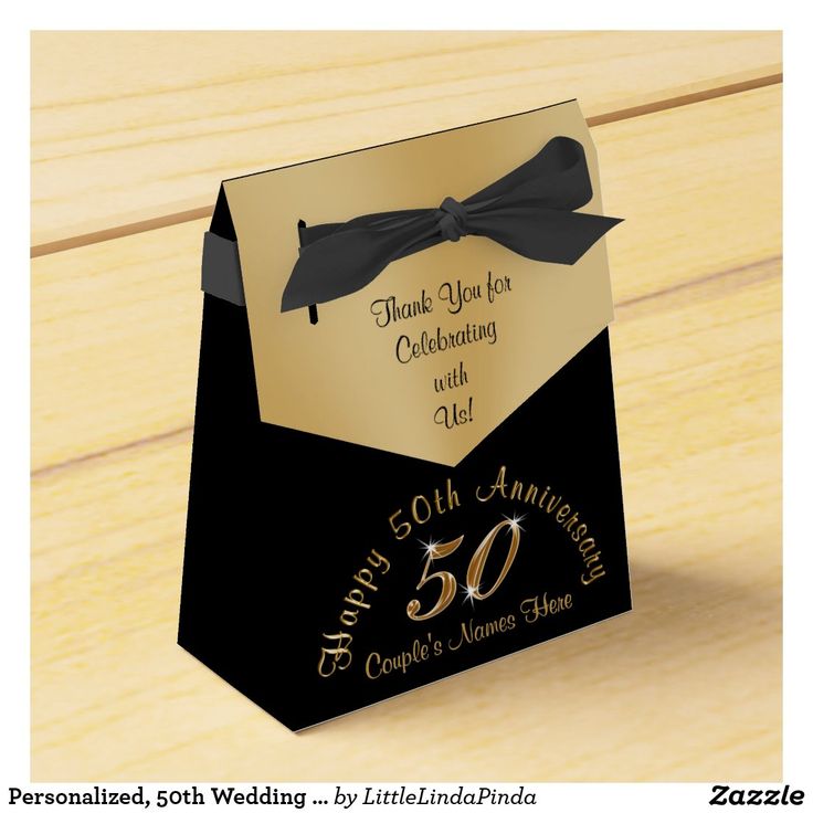 a black and gold 50th anniversary gift bag with a bow on the front that says, thank you for celebrating with us