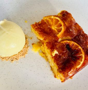 two slices of orange pie on a white plate next to a scoop of vanilla ice cream