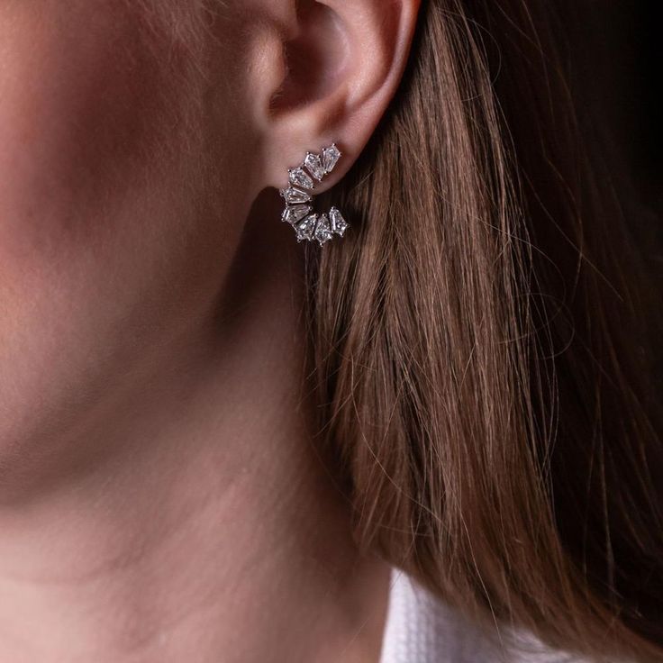 Delve into a realm of elegance with the Kite Adya Earrings, where sophistication meets innovation in a breathtaking dance of diamonds. A new twist on a timeless classic, these diamond half-hoops boast an unrivaled allure, effortlessly elevating any ensemble to celestial heights. Each earring features kite-shaped diamonds, a bespoke cut crafted exclusively for Ruchi New York's illustrious KITE collection, ensuring a look that is as rare as it is radiant.With a dazzling total weight of 2.96 carats, these earrings exude opulence and refinement, promising to captivate admirers at every turn. From boardroom meetings to glamorous soirées, these earrings are the epitome of versatility, seamlessly transitioning from day to night with unparalleled grace. Embrace the extraordinary and adorn yourself Glamorous Bridal Earrings, Diamond With Brilliant Cut, Glamorous Diamond Bridal Earrings With Brilliant Cut, Glamorous Brilliant Cut Diamond Earrings, Elegant Baguette Diamond Earrings For Anniversary, Diamond White Diamond Cluster Earrings For Evening, Diamond White Cluster Diamond Earrings For Evening, Elegant Formal Cluster Earrings With Lab Grown Diamonds, Glamorous Brilliant Cut Diamond White Earrings, Anniversary Cluster Earrings With Baguette Diamonds