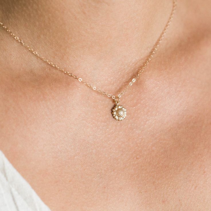 "Our dainty sunflower necklace is our newest addition to our dainty layering necklaces. Sunflowers symbolize adoration, loyalty, and longevity - making it the perfect gift for your loved ones. Available in gold filled or sterling silver. . . . . . . . . . . . . . . . . . . . . . . . . . . . . . . . . . . . . . . . . . . NECKLACE + Length: 16\" + 2\" extender + 14k gold filled -or- sterling silver sunflower 9mm pendant (hollow in back) + 14k gold filled -or- sterling silver spring clasp, jump rin Dainty Flower Charm Necklace For Wedding, Dainty Round Flower Charm Necklace, Dainty Round Pendant Flower Necklace With Flower Charm, Delicate Necklace With Flower Charm And Round Pendant, Flower Charm Necklace For Wedding, Wedding Charm Necklace With Flower Pendant, Minimalist Wedding Flower Charm Necklace, Delicate Jewelry With Flower Charm Pendant, Dainty Round Flower Necklace With Charm