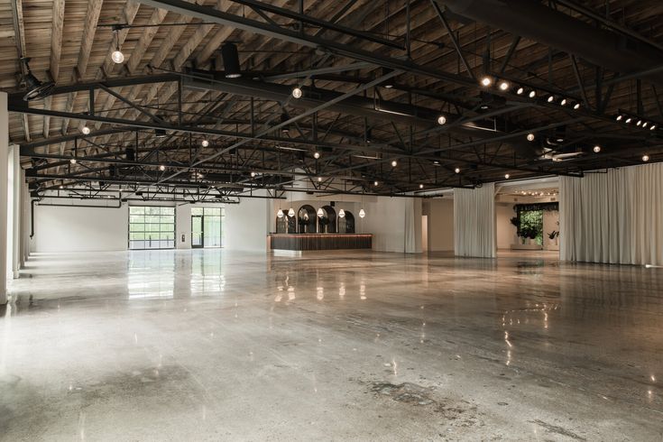 an empty room with lots of windows and lights on the ceiling is shown in this image