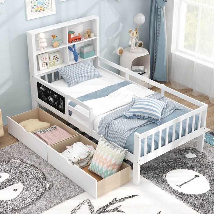 a child's bedroom with blue walls, white furniture and carpeted flooring