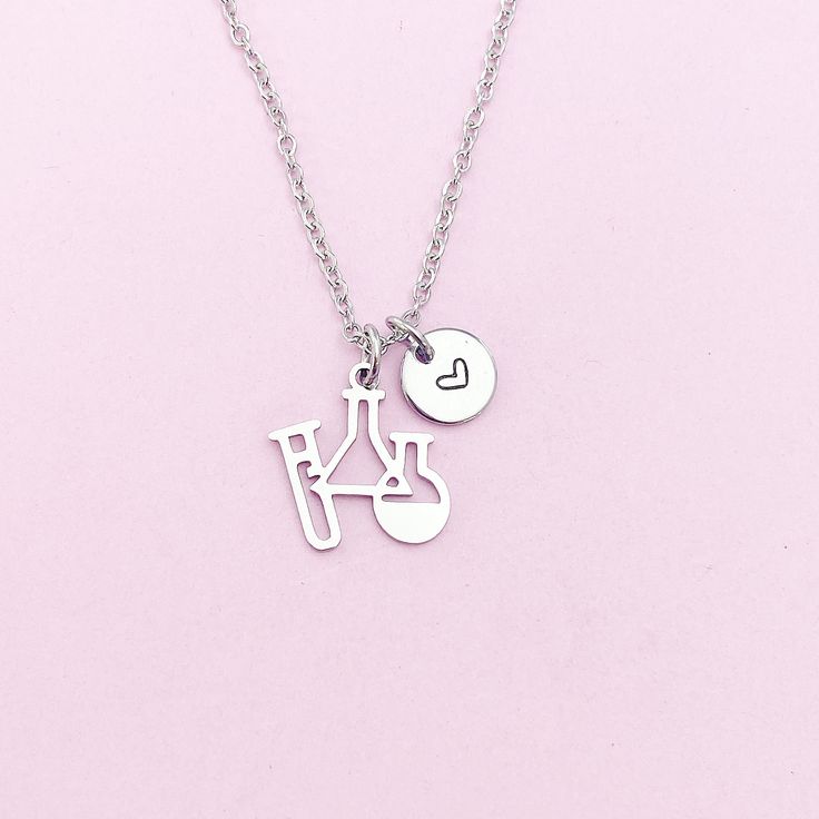 This is a silver-tone Science Laboratory Beakers charm with hand stamped initial charm on stainless steel necklace. ♥ You will receive ONE necklace. HOW TO ORDER 1) Choose the quantity. 2) Choose the initial and finish in the option or add a note to seller at checkout. 3) Add to the cart. DESCRIPTION ♥ Necklace, Stainless Steel Chain with Lobster Claw Clasp, Size: about 17.7 inches (45cm) long, 1-2mm wide, Nickel Safe,  ● The stainless steel is durable, highly resistant to water, rust and corros Silver Hand Stamped Meaningful Charm Necklace, Silver Stamped Charm Necklaces For Valentine's Day, Silver Stamped Charm Necklace For Valentine's Day, Valentine's Day Silver Stamped Charm Necklaces, Hand Stamped Silver Stainless Steel Charm Necklaces, Silver Stainless Steel Charm Necklace For Personalized Gifts, Silver Stainless Steel Charm Necklaces For Personalized Gifts, Personalized Silver Stainless Steel Charm Necklaces, Silver Stamped Charm Necklace For Birthday