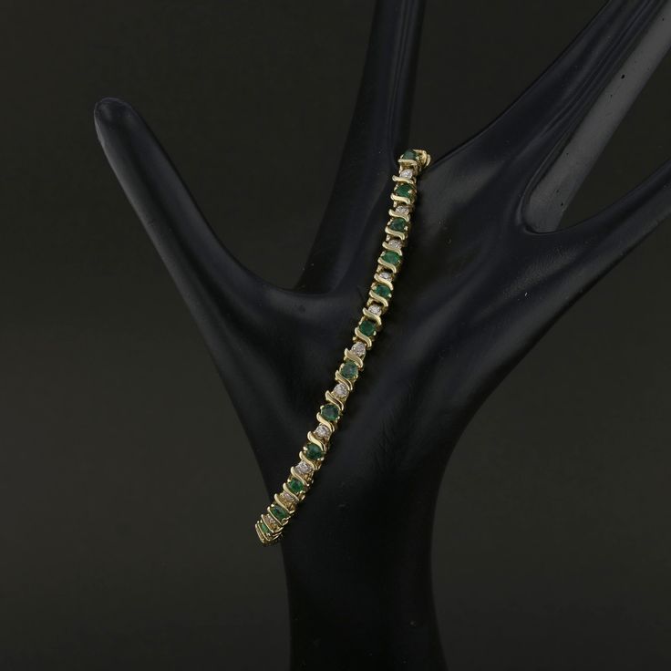 Description: This exquisite vintage 14K yellow gold bracelet features a stunning combination of vibrant green emeralds and sparkling diamonds. Weighing 9.1 grams, this elegant bracelet showcases round-cut emeralds beautifully accented by brilliant diamonds, creating a luxurious and timeless design. Perfect for special occasions or to add a touch of elegance to everyday wear, this piece is a must-have for those who appreciate vintage luxury. Specifications: Metal: 14K Yellow Gold Weight: 9.1 gram Formal Gold Bracelet With May Birthstone, Luxury Green Gold Bracelet For Anniversary, Emerald-cut Green Tennis Bracelet For Formal Occasions, Emerald Cut Green Tennis Bracelet For Formal Events, Green Diamond Bracelet For Formal Occasions, Emerald Bracelets For Formal Occasions, May Birthstone, Elegant Green Gemstone Gold Bracelet, Formal Emerald Bracelets For May Birthstone, Formal Green Emerald Cut Tennis Bracelet