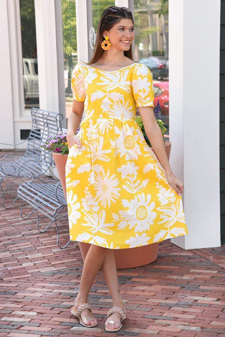 This open back midi is just precious! The floral yellow print just screams summer and is perfect for styling sneakers, wedges, or sandals! Dress is lined and has pockets. 100% COTTON BUST LENGTH XSMALL 30" 41.5" SMALL 32" 42" MEDIUM 34" 42.5" LARGE 36" 43" Yellow Relaxed Fit Dress For Summer, Casual Lemon Print Summer Dress, Casual Summer Lemon Print Dress, Casual Summer Dress With Lemon Print, Casual Sunflower Print Spring Dress, Casual Short Sleeve Lemon Print Dress, Yellow Vacation Dress With Pockets, Casual Yellow Sunflower Print Dress, Yellow Dress With Pockets For Vacation