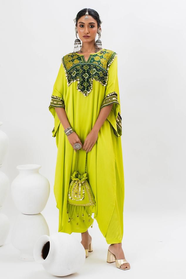 Green long kaftan kurta with hand embroidered ajrakh patch yoke in front. Comes with pant.
Components: 2
Pattern: Embroidered
Type Of Work: Ajrakh, Sequin, Zari, Thread
Neckline: Notched
Sleeve Type: Batwing
Fabric: Satin
Color: Green
Other Details: 
Note: Potli bag held by the model is not for sale
Occasion: Mehendi and Haldi - Aza Fashions Traditional Pattern Maxi Kaftan For Festivals, Traditional Pattern Maxi Length Kaftan For Festivals, Traditional Maxi Kaftan For Festivals, Festive Traditional Pattern Maxi Length Kaftan, Festive Maxi Length Kaftan With Traditional Patterns, Traditional Patterned Floor-length Kaftan For Festivals, Traditional Pattern Maxi Kaftan For Ceremonies, Festive Floor-length Kaftan With Traditional Patterns, Bohemian Traditional Wear For Eid In Maxi Length