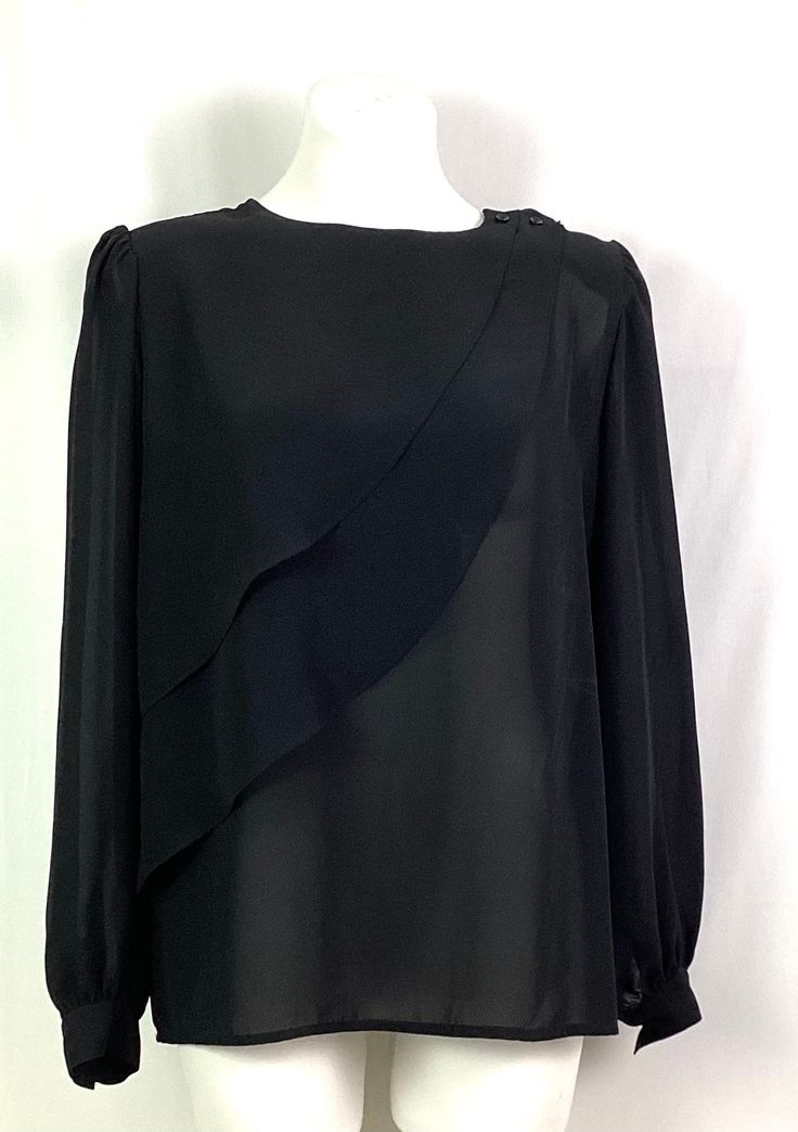 Astor one-poly silk  crêpe Elegant dress blouse Size 14 Buttons at the left shoulder for closure Two lovely flowing panels rising up to the left shoulder Slight padding at the shoulders 100% polyester-very rich, flowing silky fabric Machine wash tag Like new Formal Blouse With Draped Long Sleeves, Formal Long Sleeve Blouse With Draped Sleeves, Elegant Formal Tops With Draped Sleeves, Formal Blouse With Draped Sleeves For Spring, Formal Silk Blouse With Draped Sleeves, Elegant Asymmetrical Blouse With Draped Sleeves, Elegant Blouse With Draped Asymmetrical Sleeves, Silk Long Sleeve Blouse For Evening, Elegant Blouse With Draped Sleeves In Georgette