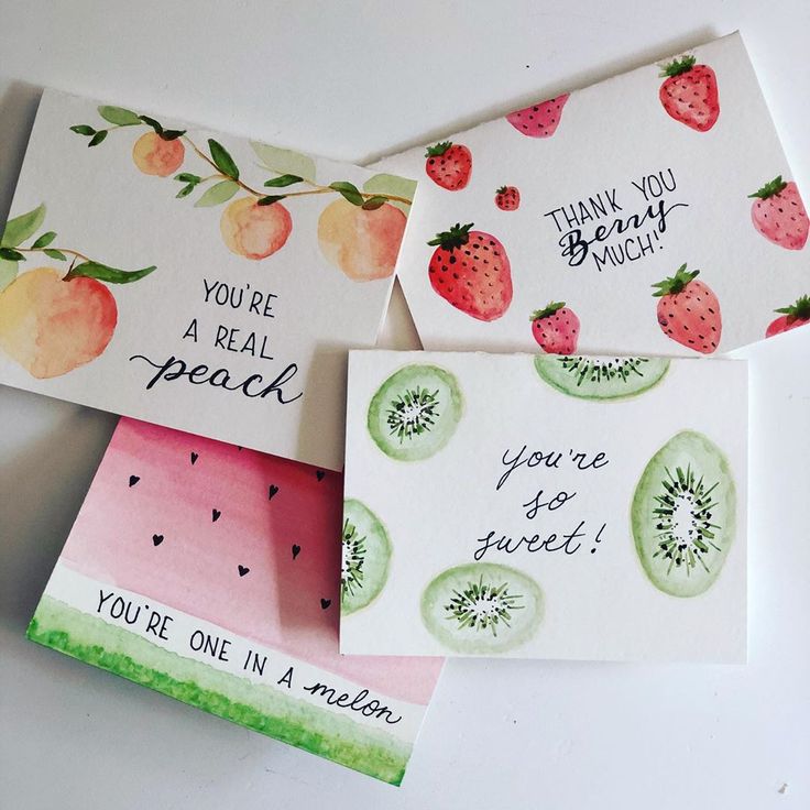 three cards with fruit on them sitting next to each other