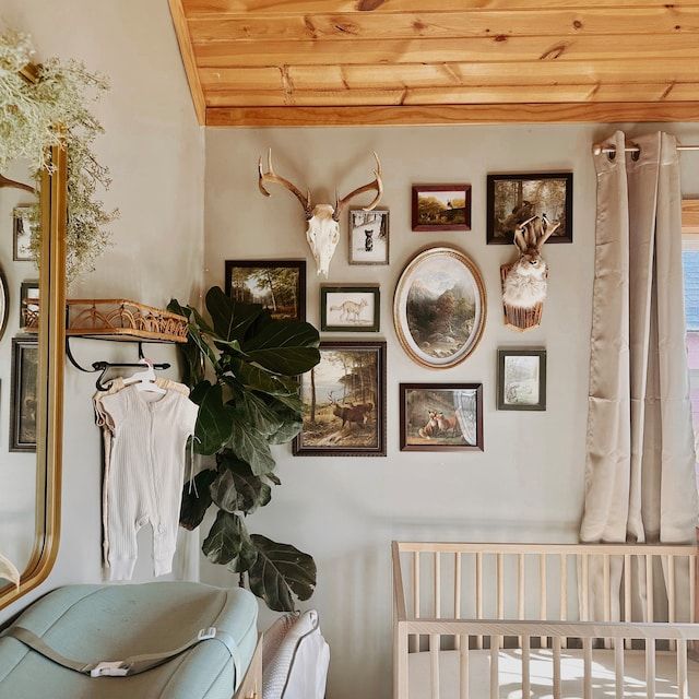 a baby's room with pictures on the wall and a crib next to it