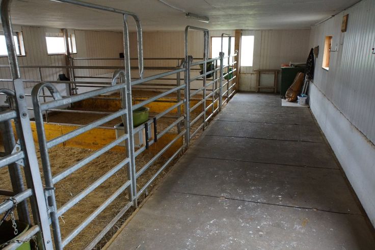 the inside of a barn with metal railings