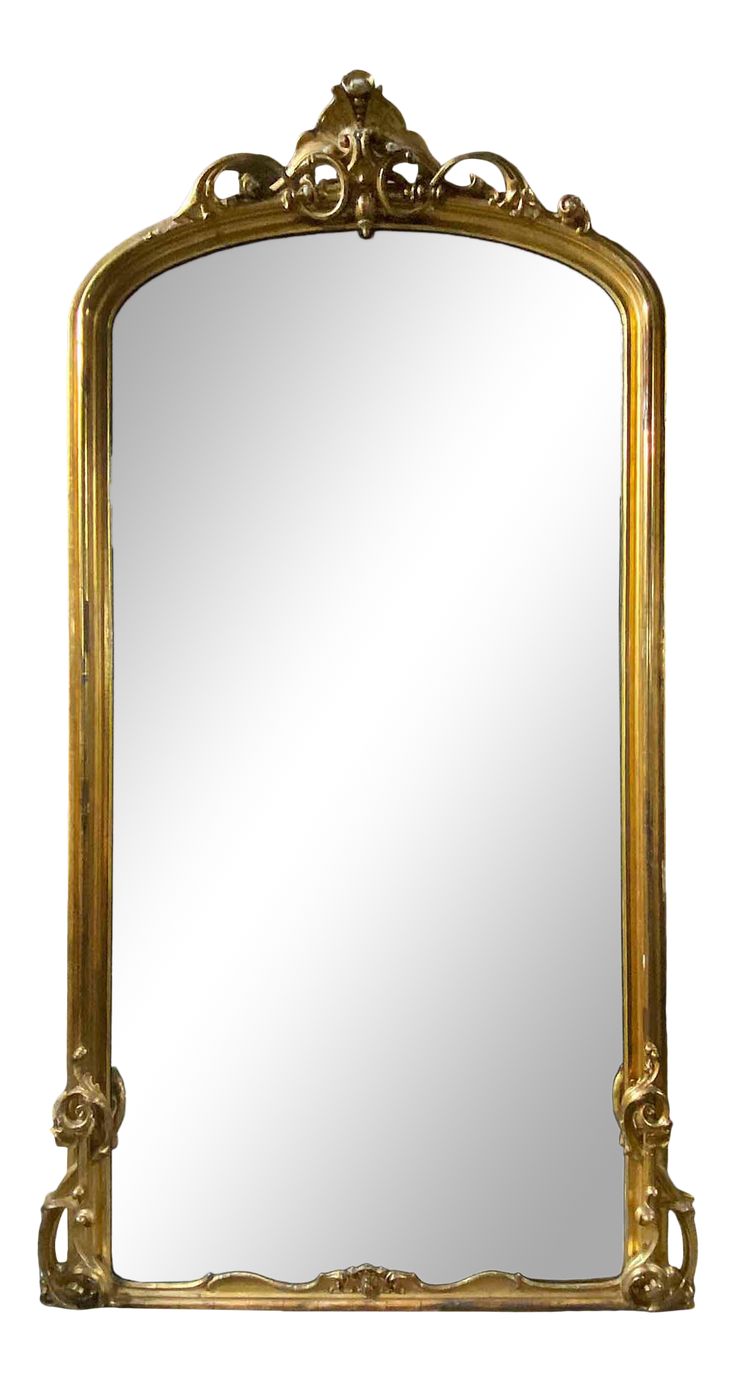 an ornate gold framed mirror against a white background