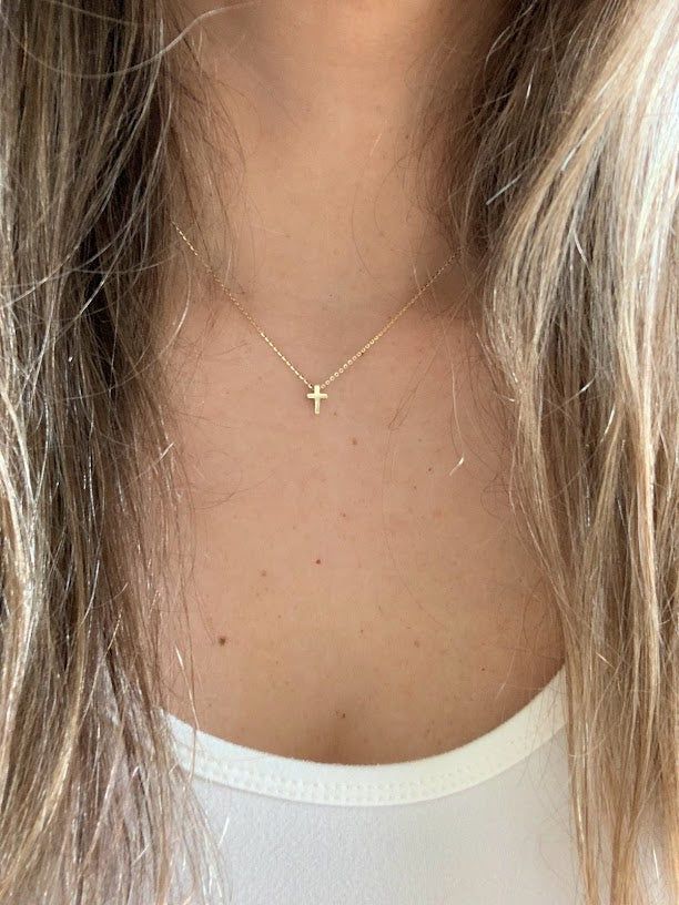 Ensure lasting memories for the special moments in your life with this 14K gold tiny cross necklace, a religious jewelry gift. Crafted for women of Christian faith, this small cross pendant is bold and designed in a 3D mini cross configuration. Free shipping offered. This piece is beautiful, elegant, shiny, and suitably sturdy for a baptismal gift. ⁙ Materials: 14K Yellow Gold⁙ Dimensions: 8MM Height by 6MM Width in diameter, the chain is very sturdy and 1MM wide, it is 16"-18" it can be hooked Christian Cross Jewelry, Small Gold Cross Pendant, Tiny Gold Cross Necklace, Little Cross Necklace, Real Gold Cross Necklace, Mini Cross Necklace, Small Gold Cross Necklace, Everyday Cross Pendant Charm Necklace, Dainty 14k Gold Cross Pendant Charm Necklace