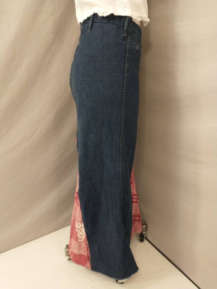 "Fabulous handmade from Landlubber jeans, denim skirt. Period 1970's , from the original owner (and seamstress) Made by Jill. Insert fabric is cotton, red bandana look, stamp on edge preserved. raw finish to denim lower edge. Looks to be made to sit low waisted - low rise in front but higher waisted in back. Many possibilities on what this could be paired up with. Four season. 100% Cotton, made in the USA, traditional denim fabric. Very good quality and construction. Very good condition, light w Bohemian High Rise Fitted Bottoms, Bohemian Fitted Medium Wash Bottoms, Fitted Bohemian Medium Wash Bottoms, Bohemian Fitted Dark Wash Bottoms, Fitted Denim Skirt For Spring Festival, Fitted Medium Wash Bottoms For Festival, Fitted Denim Bottoms For Festival, Bohemian Reworked Bottoms For Spring, Bohemian Stretch Denim Bottoms