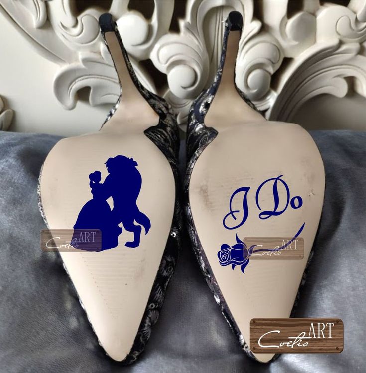 pair of shoes decorated with the silhouettes of two people kissing on top of each other