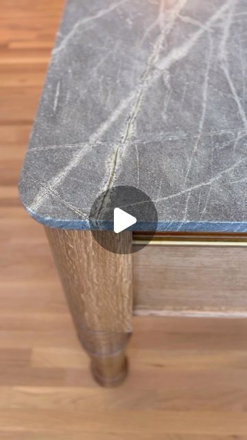 a close up of a table on a wooden floor with an arrow pointing to the top