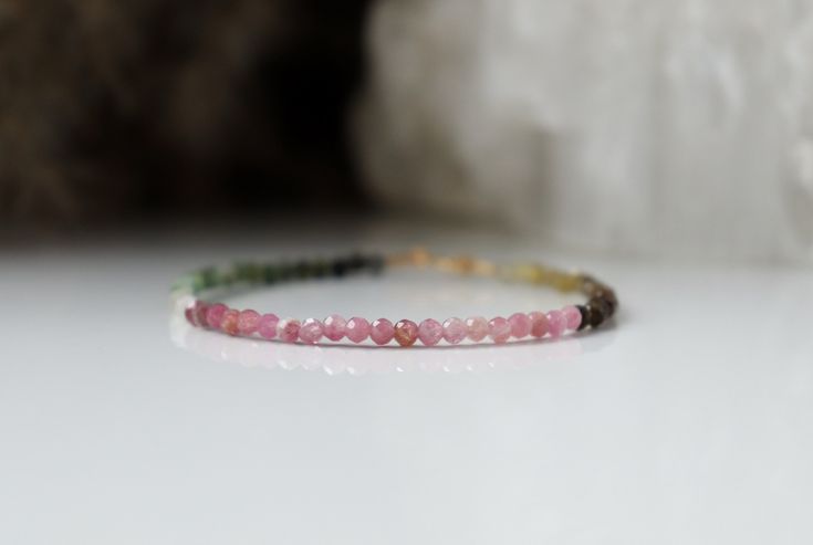 "Delicate Watermelon Tourmaline bracelet is super dainty, elegant and just perfect for stacking. Bracelet has gorgeous shades of pink, green and a hint of golden hues with amazing flashes. Tourmaline jewelry is a perfect present for October birthday people because it is an October Birthstone. The main magical properties of Watermelon Tourmaline are that it is able to affect the human mind, expanding its capabilities and improving memory. The energy potential of the stone will protect its owner f Minimalist Pink Round Bracelet, Pink Natural Stones Bracelet For Everyday, Everyday Pink Bracelets With Natural Stones, Everyday Pink Natural Stone Bracelets, Spiritual Pink Faceted Bracelet, Adjustable Tourmaline Gemstone Bracelet, Adjustable Tourmaline Gemstone Bracelets, Spiritual Tourmaline Gemstone Bracelets, Elegant Pink Tourmaline Bracelets