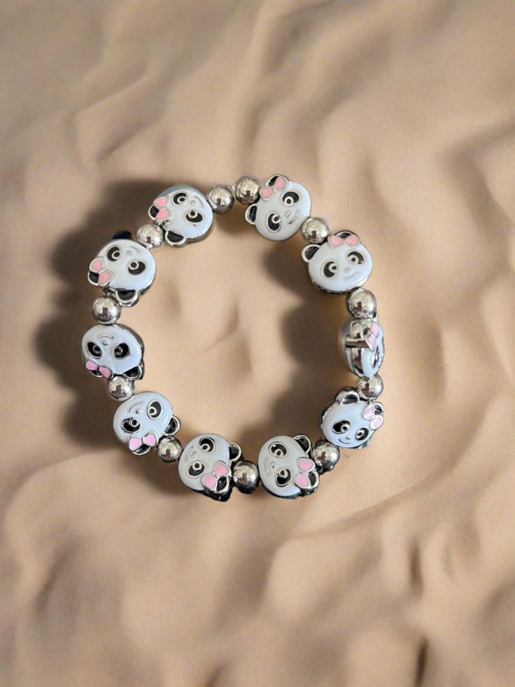 Description Add some playful charm to your look with this Enamel Metal Panda beaded Stretch bracelet. Featuring a stretchy design and a cute Panda face with an enamel finish, this bracelet brings a touch of whimsy to any outfit. Perfect for animal lovers and fashion enthusiasts alike! Details Length: 7" Black, pink and white enamel with rhodium colored metal 11mm x 14mm bead size 10 beads Panda face shape with enamel finish Nickel free Enamel and zinc alloy Features One of a kind, fashion jewelr Panda Face, Creative Memories Scrapbooking, Creative Memories, Cute Panda, Beaded Stretch Bracelet, Face Shape, Animal Lovers, White Enamel, Stretch Bracelet