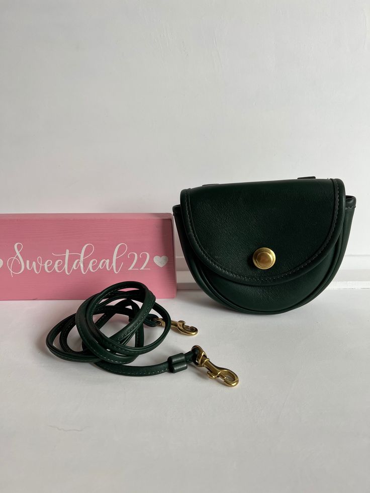 "Classic Vtg Coach Mini Belt/crossbody bag Green leather with brass hardware Small interior with inner slip pocket, outer slip pocket covered by a flap and secured with a snap button closure Detachable 46\" strap to be worn over shoulder or crossbody Measures: 5 1/2\"L, 5\"H, 2\"W Belt loops to attach to your belt as a fanny pack to be hands free Great for cards/ lipstick and small items Made in the United States #1295-337 Cleaned, conditioned and ready to wear! Questions? Just ask More vtg coac Travel Belt Bag With Gold-tone Hardware, Travel Shoulder Belt Bag With Gold-tone Hardware, Gold-tone Hardware Belt Bag For Travel, Classic Crossbody Belt Bag For Everyday, Crossbody Flap Bag With Brass Hardware For Travel, Travel Crossbody Flap Bag With Brass Hardware, Classic Belt Bag With Mobile Phone Pocket, Crossbody Saddle Bag With Brass Hardware For Travel, Classic Shoulder Belt Bag With Mobile Phone Pocket