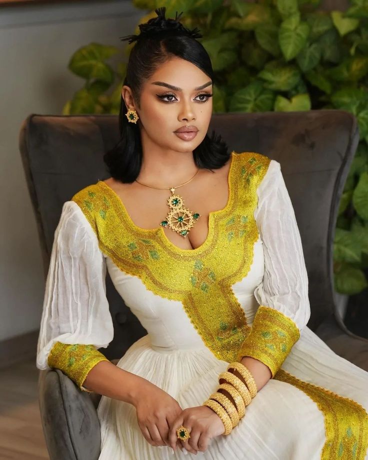 This elegant golden Habesha dress displays traditionally unique craftmanship with modern finishing and pattern style. The gorgeous essence of the dress offers beautiful look for any special occasions planned. Material Cotton Menen Thread Estimated delivery : 1 week to 2 weeks Contact WhatsApp +1(304)-306-2784Email: contact@ethiopian.store Elegant Gold Embroidered Wedding Dress, Traditional Gold Gown For Ceremonial Occasions, Traditional Gold Embroidered Festive Dress, Gold Floor-length Traditional Wear For Ceremonial Occasion, Gold Floor-length Traditional Wear For Ceremonial, Gold Floor-length Ceremonial Traditional Wear, Gold Embroidered Festive Dress, Elegant Gold Embroidered Dress For Festive Occasions, Elegant Gold Embroidered Festive Dress