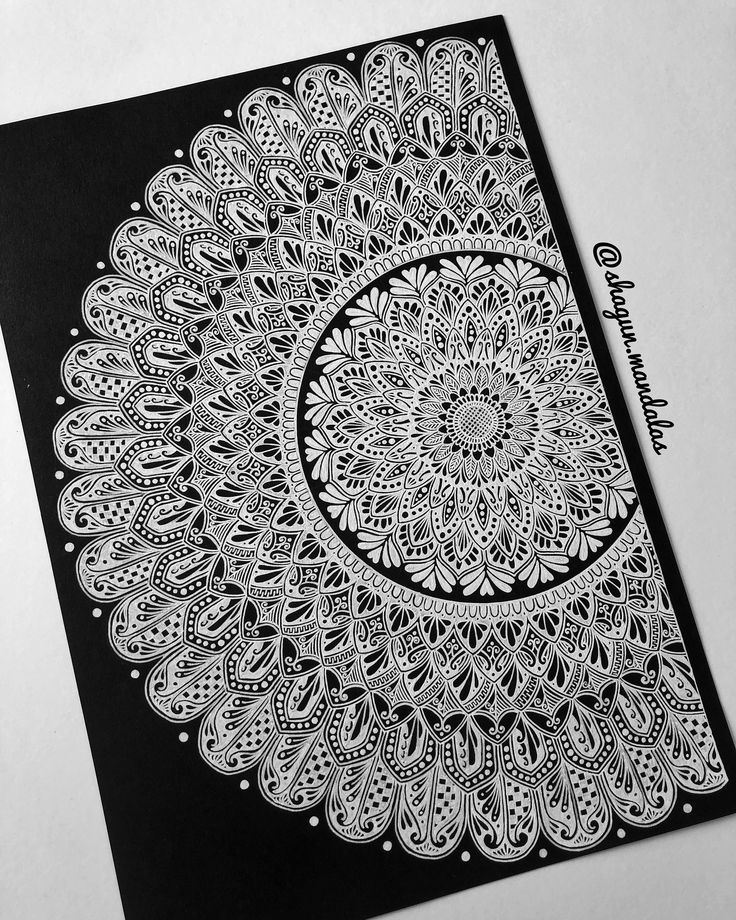 a black and white drawing on top of a piece of paper with an intricate design