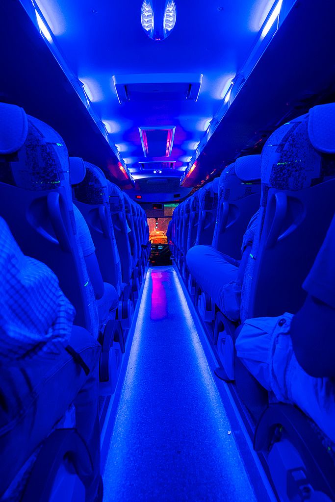 the inside of an airplane with blue lights and no one in it or someone else