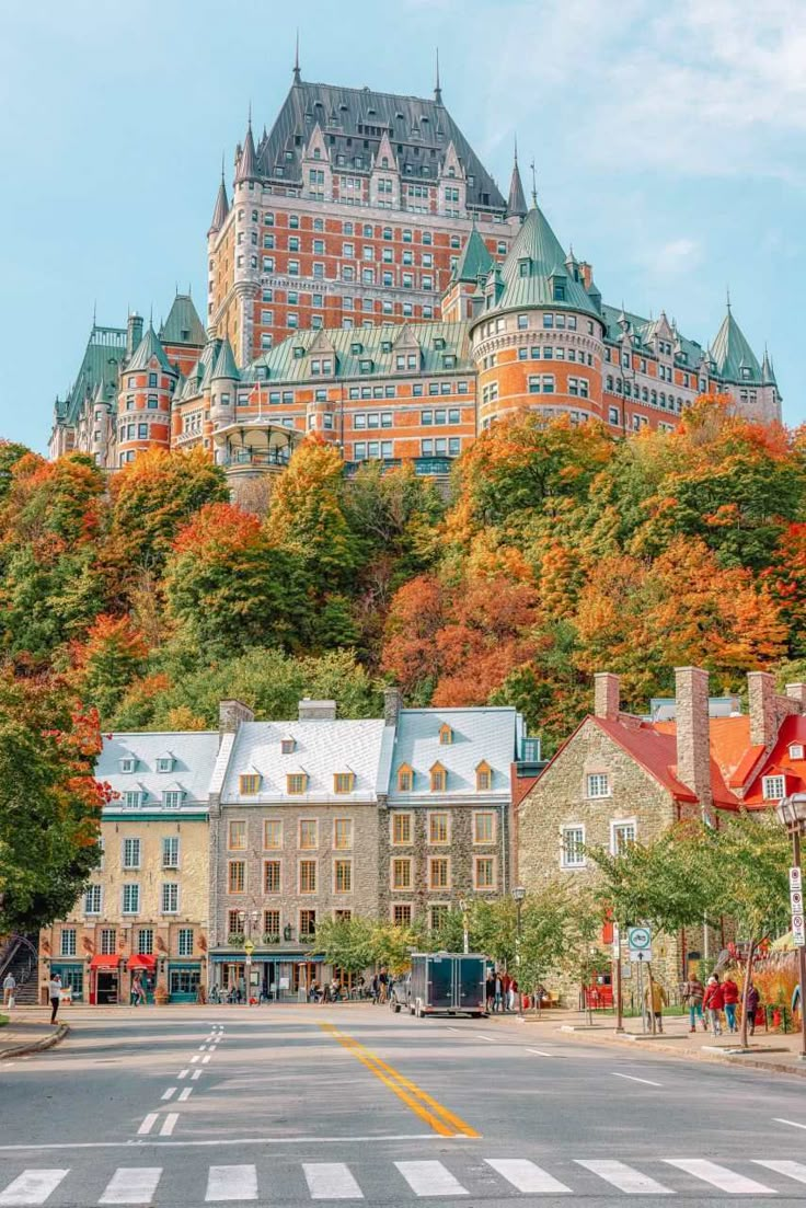 a large building on top of a hill with trees around it