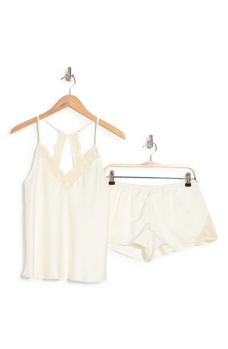 Perfect for romantic evenings, this elegant pajama set crafted in smooth matte satin includes a lace-trimmed racerback camisole and matching shorts. 2-piece set Top has V-neck; adjustable straps; open racerback; scalloped lace trim; satin construction Shorts have elastic waist; scalloped lace trim; satin construction 100% polyester Hand wash, dry flat Imported Model stats: 5'10" height, 32" bust, 25" waist, 36" hip. Model is wearing size S. Elegant Night Sets For Summer, Elegant Summer Night Sets, Chic Short Sleepwear For Loungewear, Feminine Cami Sleepwear For Night, Elegant Cami Sleepwear For Loungewear, Spring Sleeveless Night Sets, Sleeveless Night Sets For Spring, Summer Sleep Camisole Sets, Feminine Sleeveless Sleep Sets