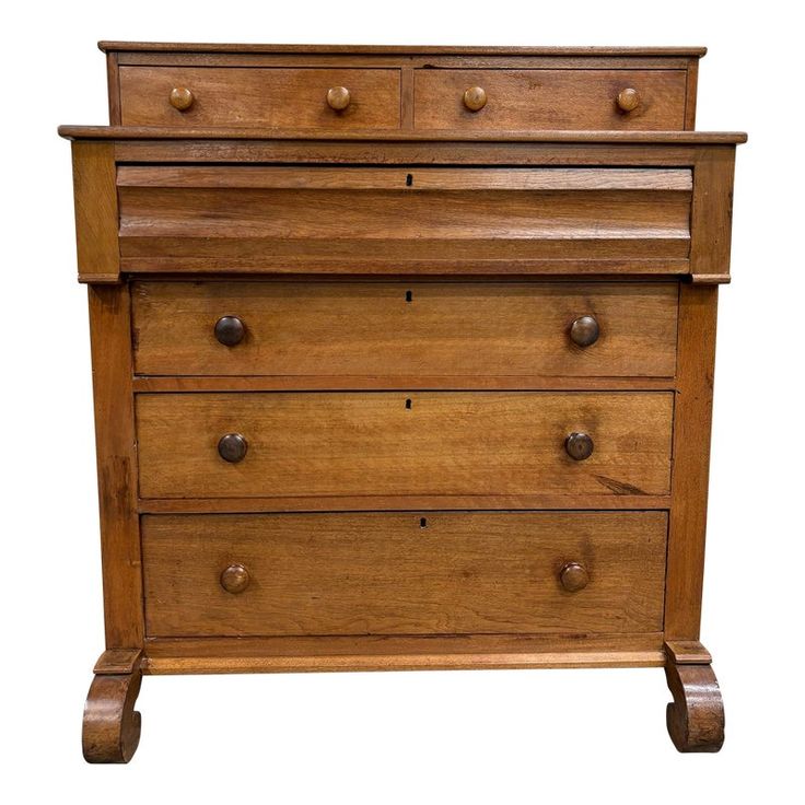 an old wooden dresser with three drawers and two knobs on the front, isolated against a white background