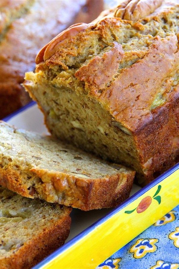 sliced banana bread sitting on top of a blue and yellow plate next to another loaf