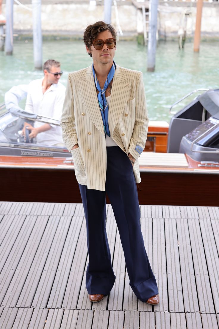 a man standing on top of a wooden dock