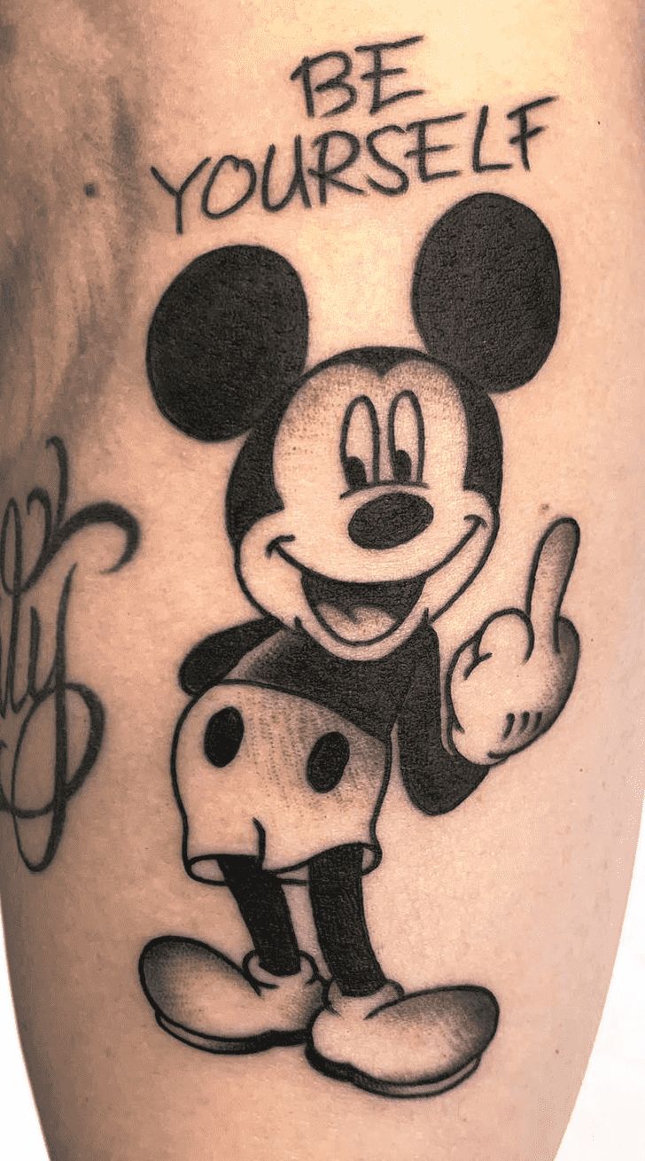 a mickey mouse tattoo with be yourself written on it