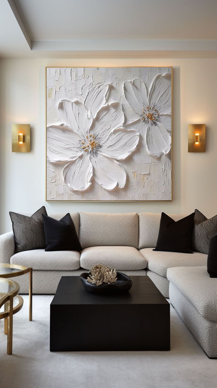 a living room filled with furniture and a large flower painting on the wall above it