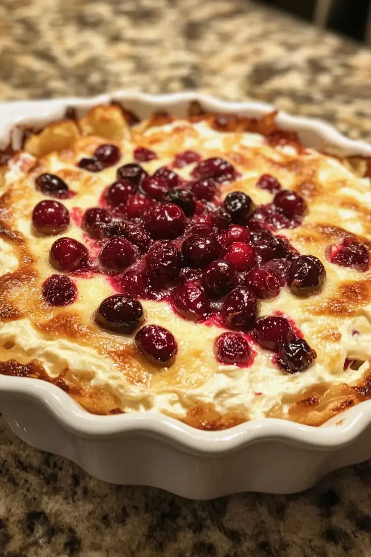 a pie with cranberries in it sitting on a counter