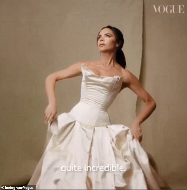 a woman in a white dress posing for the camera