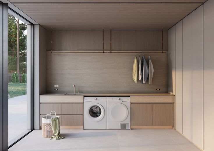 a washer and dryer in a room with sliding glass doors on the outside