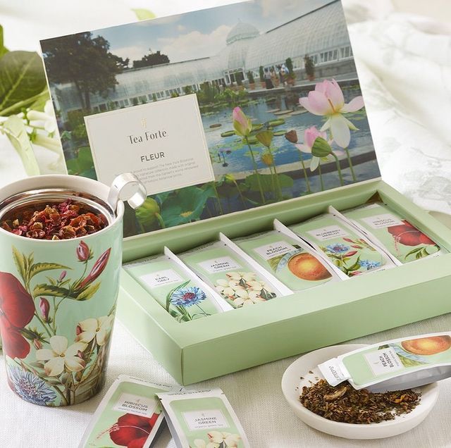 a cup of tea and some cards on a table