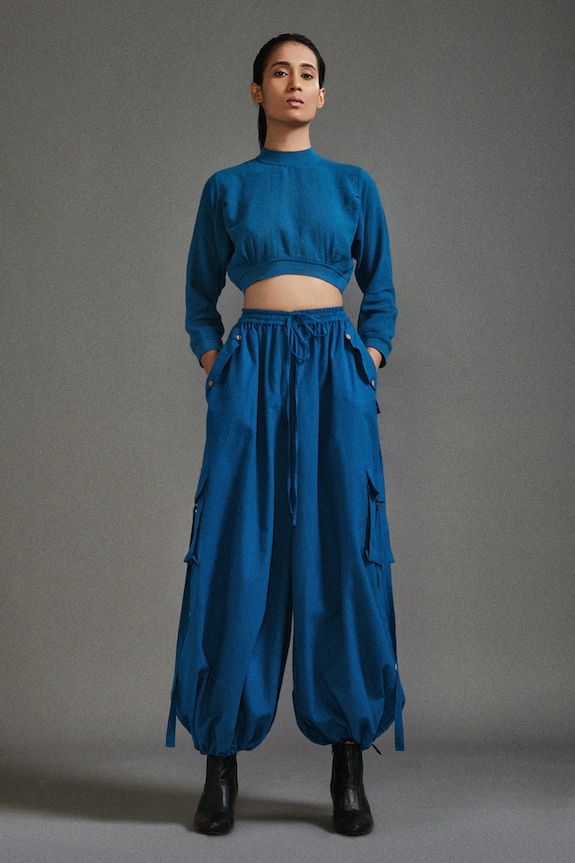 Blue three fourth sleeves crop top in textured cotton with ribbed waistline, neckline and sleeve hem. Paired with a baggy-fit cargo pants with strap details on pockets. - Aza Fashions Blue Cropped Cotton Pants, Pant For Women, Baggy Cargo Pants, Blue Crop Top, Eco Friendly Clothing, Blue Crop Tops, Clothing Material, Ethical Clothing, Cargo Pants Women