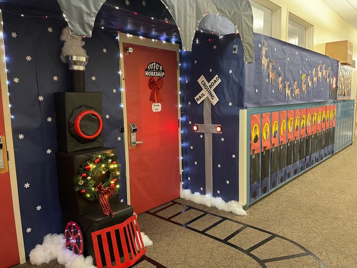 an indoor christmas display with decorations and lights on the front door, decorated in blue and red