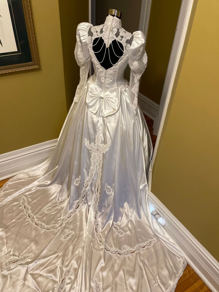 a white wedding dress on display in a room