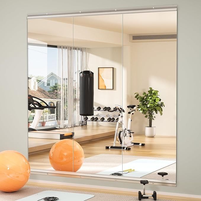 an exercise room is reflected in the mirror