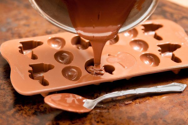 chocolate being poured into an ice tray