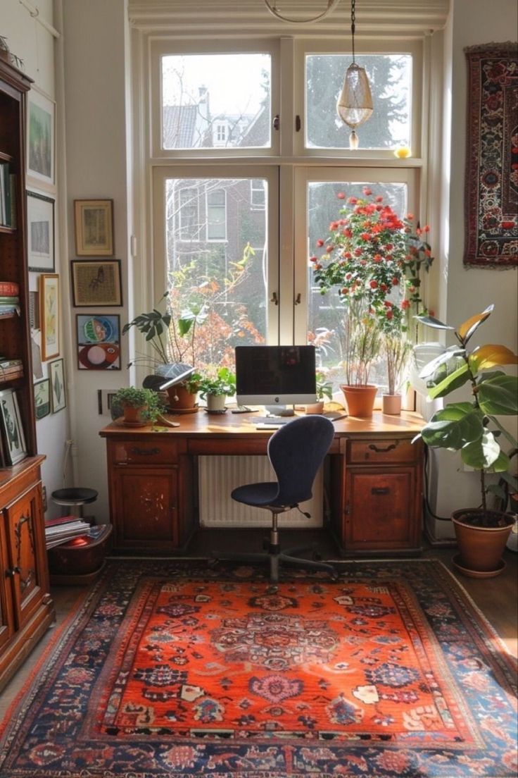 a room with a desk, bookshelf and potted plants on the window sill