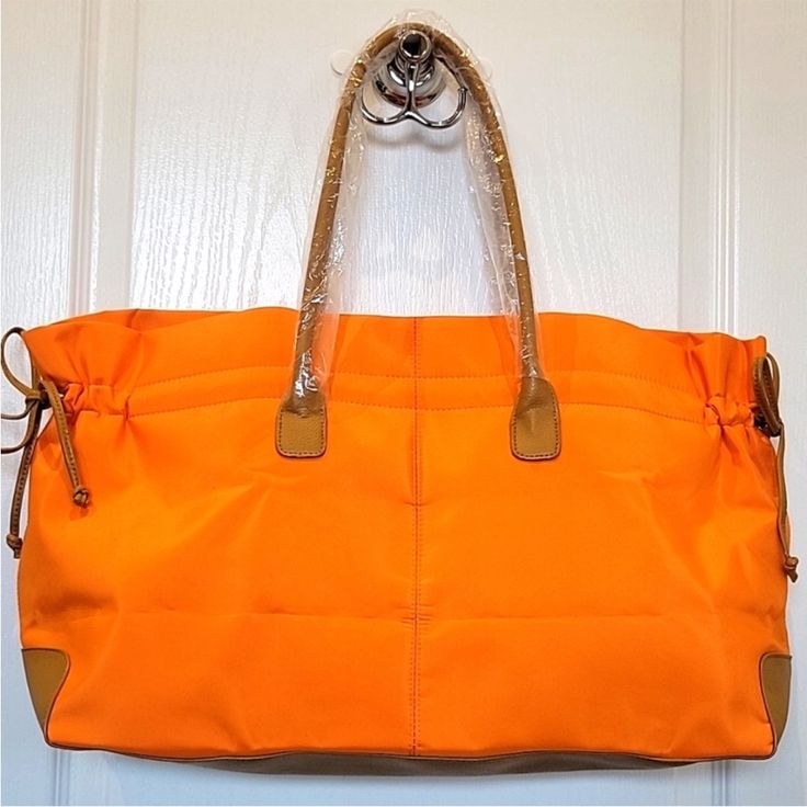 Nwot Lancome Orange Nylon Large Tote Beautiful Lancome Orange Nylon Large Tote. New Without Tags, No Stains, And No Rips. Approximate Measurements: 21.5" X 11.5" X 6" Casual Nylon Shoulder Bag With Luggage Sleeve, Casual Nylon Tote Travel Bag, Casual Nylon Bags With Leather Handles, Casual Nylon Bag With Leather Trim, Large Capacity Nylon Shoulder Bag For Errands, Travel Nylon Shoulder Bag With Leather Trim, Nylon Bags With Leather Trim, Orange Nylon Bags For Everyday Use, Orange Nylon Shoulder Bag For Daily Use