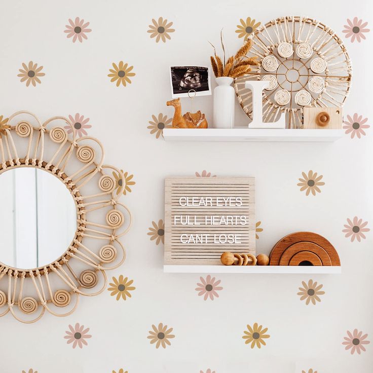 there are two shelves with decorative items on them and one has a mirror above it