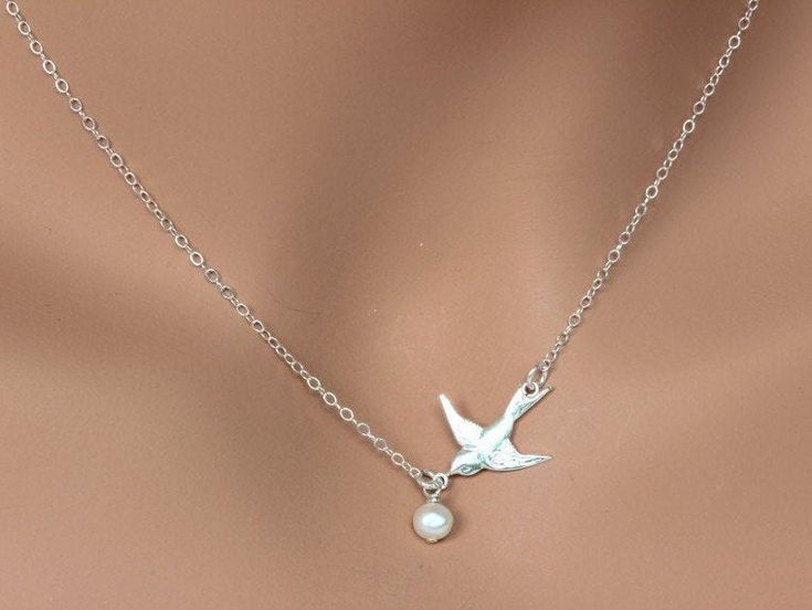 Dove Bird Necklace, Freshwater Pearl Necklace This necklace express for love and friendship All metal components onto High Quality Sterling Silver or 14k gold fill. This beautiful necklace consists of, -Sterling Silver Dove Pendent, -5mm Gem quality Freshwater Pearl and -Sterling Silver cable chain with end to end to Spring Claw. -Come up with beautiful ribbon gift box and -Care instruction pack . MORE BIRD https://www.etsy.com/shop/rainbowearring?ref=hdr_shop_menu&search_query=bird PET LOVE Adjustable Bird Design Jewelry For Gifts, Adjustable Bird Design Jewelry As Gift, Adjustable Bird Design Jewelry Gift, Elegant Bird Design Jewelry For Gift, Elegant Sterling Silver Necklace With Bird Design, Elegant Bird Design Jewelry Gift, Silver Bird Shaped Jewelry For Gifts, Silver Bird-shaped Jewelry For Gift, Silver Bird-shaped Jewelry As Gift